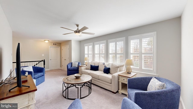 carpeted living room with ceiling fan