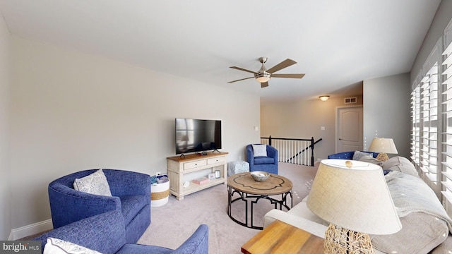 carpeted living room featuring ceiling fan