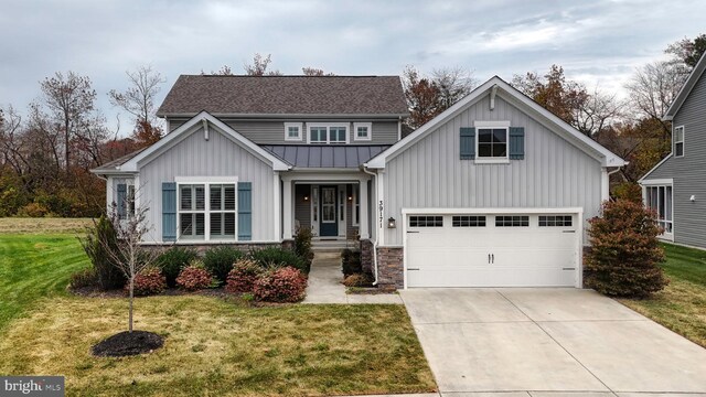 view of front of property with a garage and a front lawn