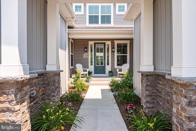 view of exterior entry featuring covered porch