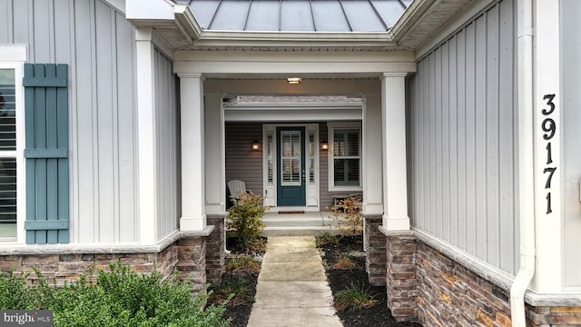 view of exterior entry with a porch