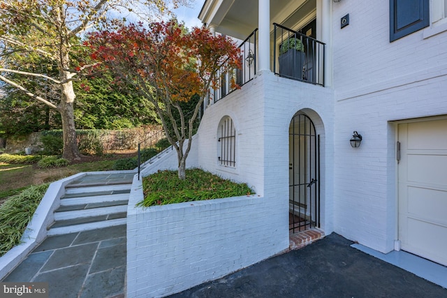 doorway to property with a garage