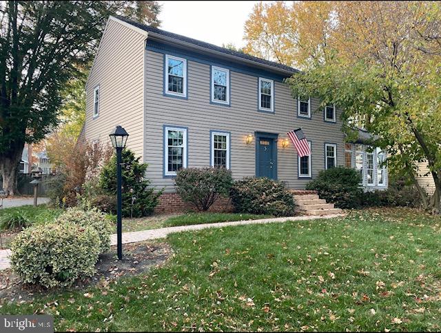 colonial inspired home with a front yard