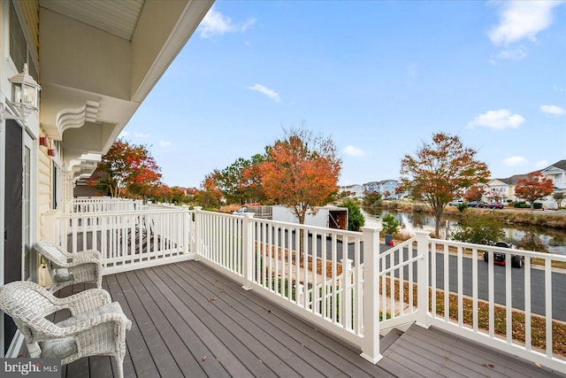 wooden deck featuring a water view