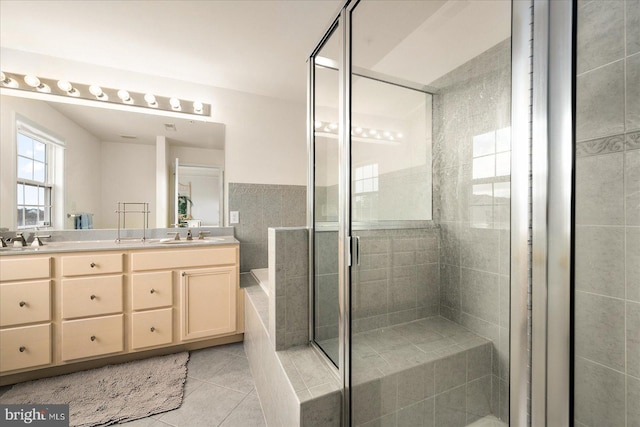 bathroom with vanity, a shower with shower door, and tile patterned floors