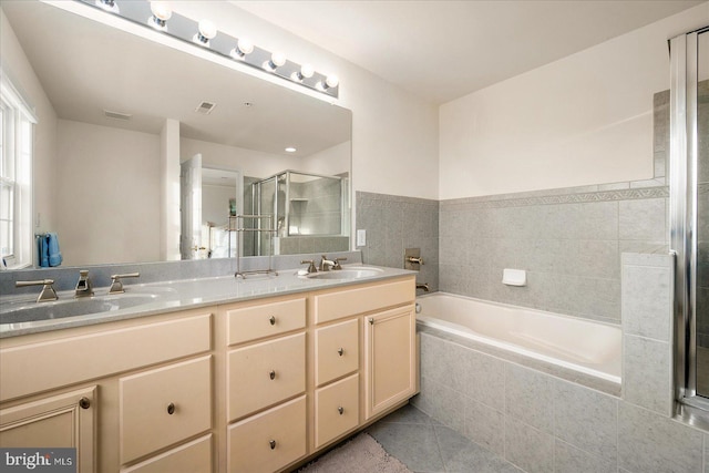 bathroom with independent shower and bath, tile patterned flooring, and vanity