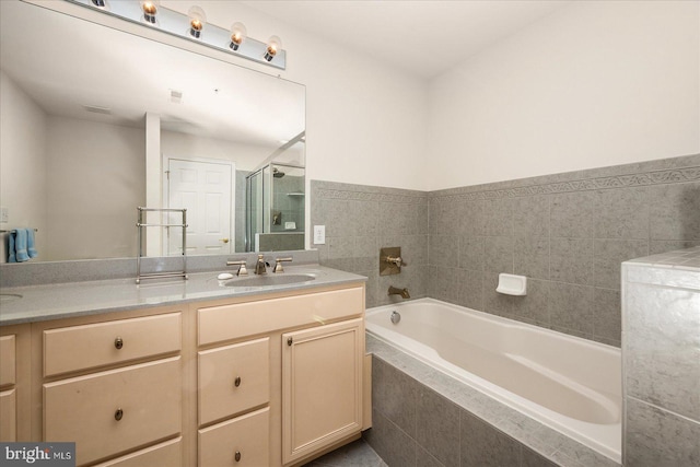 bathroom featuring plus walk in shower and vanity