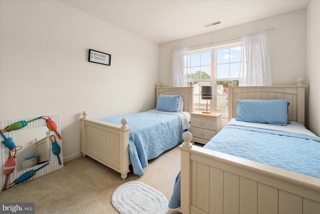 bedroom featuring light carpet