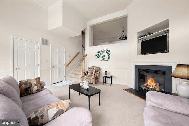 carpeted living room featuring ornamental molding and a towering ceiling