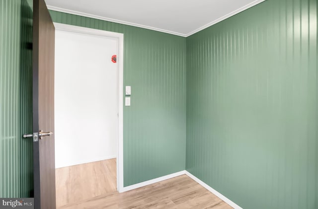 interior space with hardwood / wood-style floors and crown molding