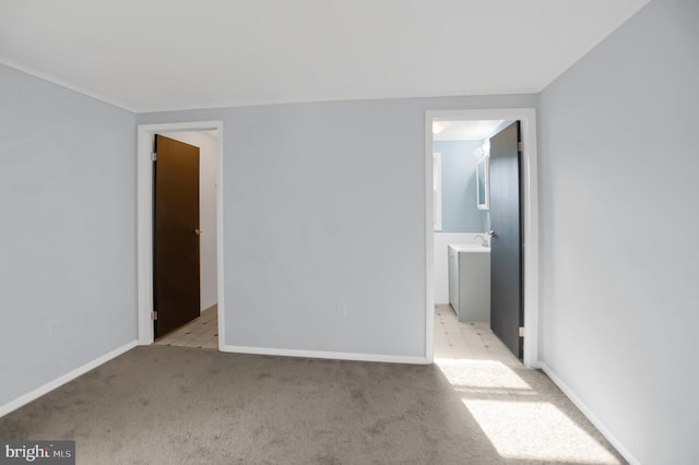 empty room with sink and light carpet