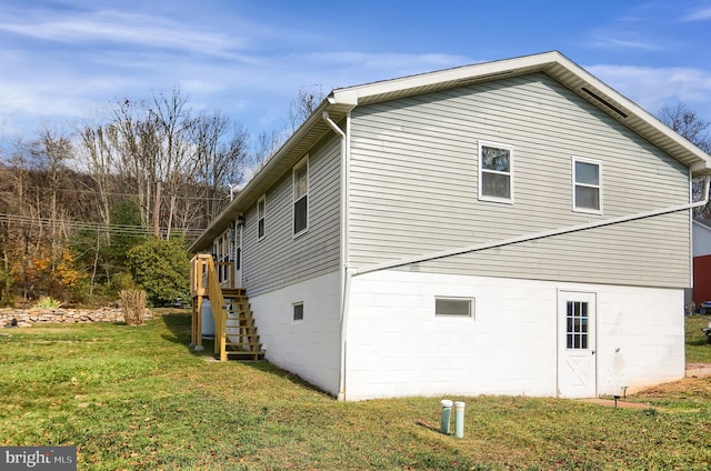 view of side of property with a lawn