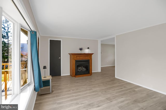 living room with ornamental molding and light wood-type flooring