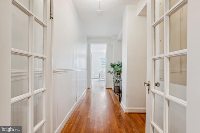 hallway with hardwood / wood-style floors