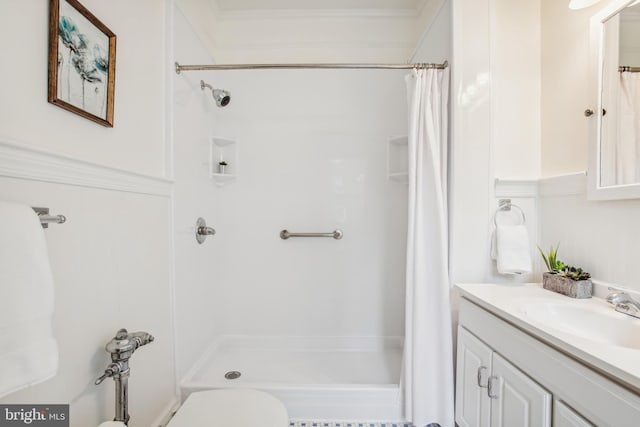 bathroom featuring walk in shower, vanity, toilet, and ornamental molding