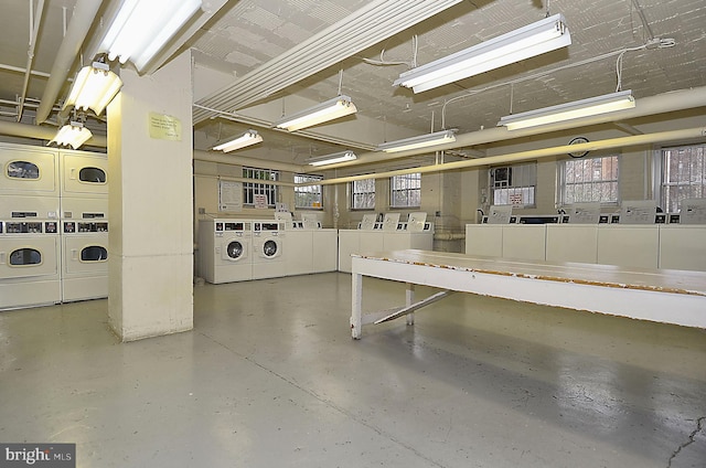 garage with stacked washing maching and dryer and washing machine and dryer