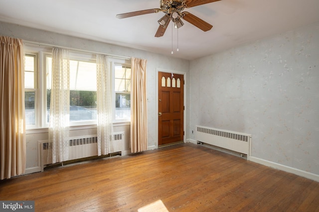 entrance foyer featuring ceiling fan, wood-type flooring, and radiator heating unit