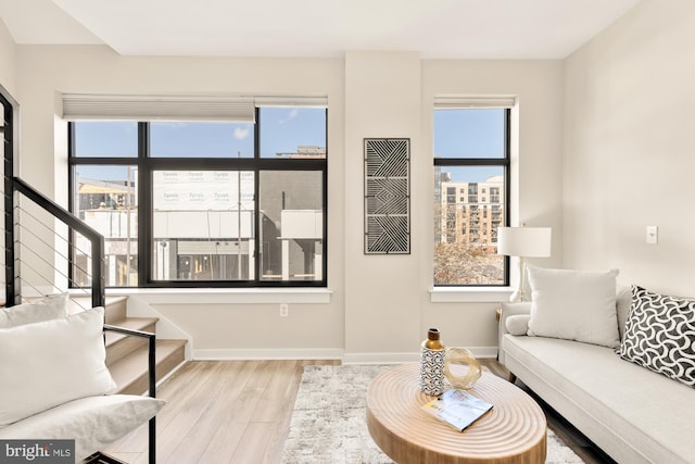 living room with a wealth of natural light and light hardwood / wood-style floors