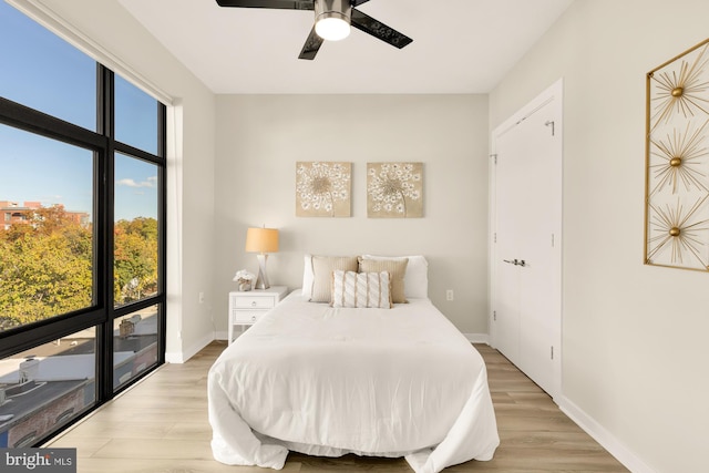 bedroom with ceiling fan and light hardwood / wood-style flooring