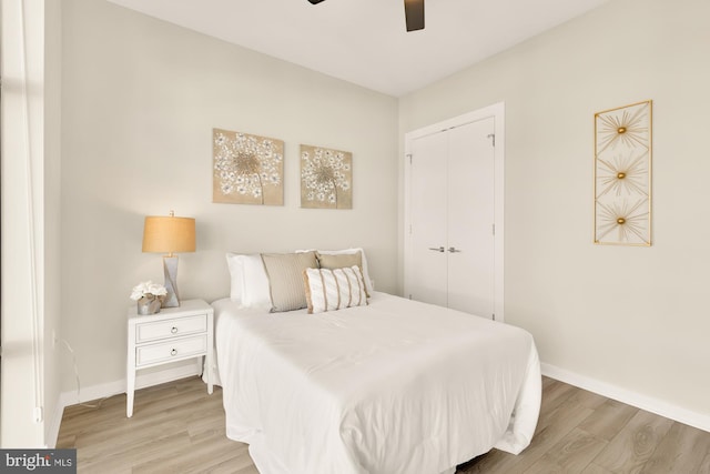 bedroom with a closet, ceiling fan, and light hardwood / wood-style floors