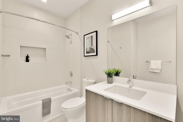 full bathroom with toilet, vanity, and tiled shower / bath