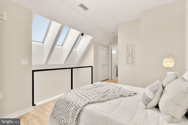 bedroom featuring light hardwood / wood-style flooring and vaulted ceiling