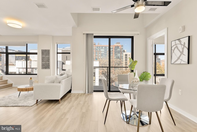 dining room with light hardwood / wood-style flooring and ceiling fan