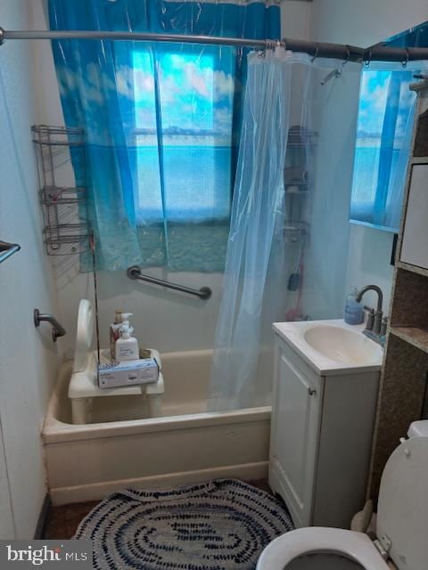 full bathroom featuring toilet, shower / tub combo, a wealth of natural light, and vanity