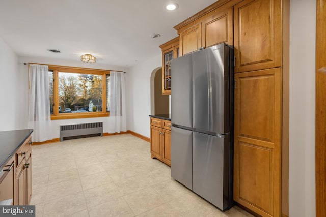 kitchen with stainless steel refrigerator and radiator