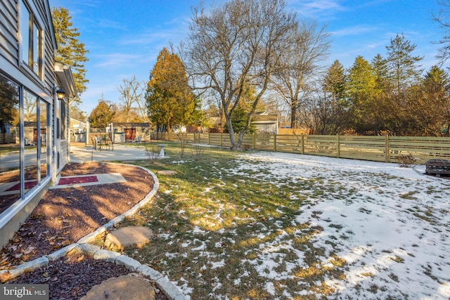 snowy yard with a patio