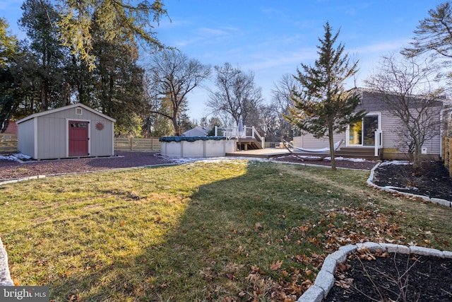 view of yard with a storage unit and a covered pool