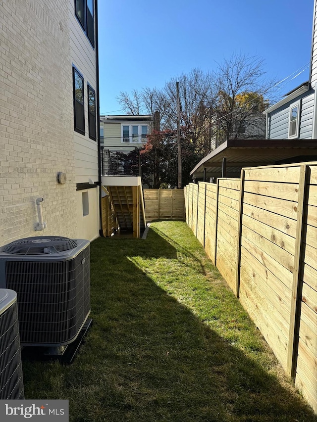 view of yard with central air condition unit