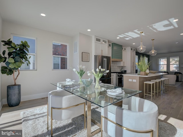 dining area with light hardwood / wood-style floors