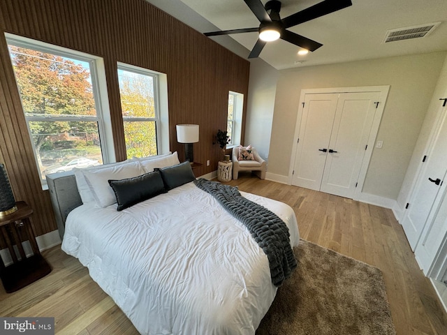 bedroom with a closet, ceiling fan, and light hardwood / wood-style floors