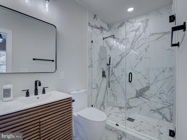 bathroom featuring walk in shower, vanity, and toilet