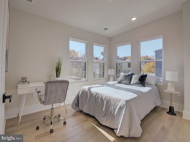 bedroom featuring light hardwood / wood-style floors and multiple windows