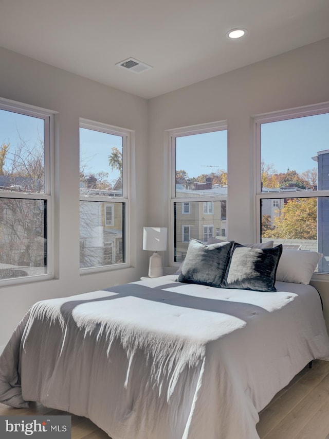 bedroom featuring light hardwood / wood-style floors and multiple windows