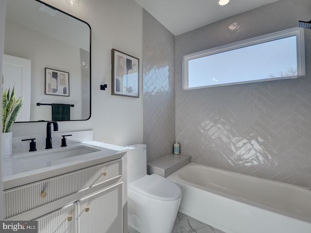 bathroom with a tub to relax in, vanity, and toilet