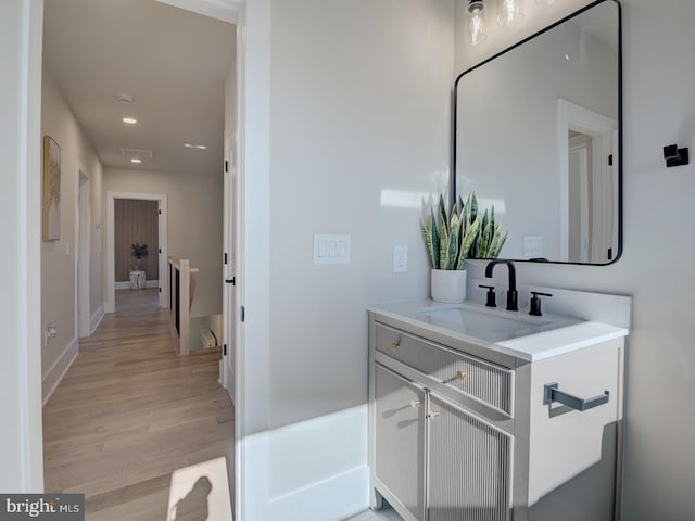 bathroom with hardwood / wood-style floors and vanity