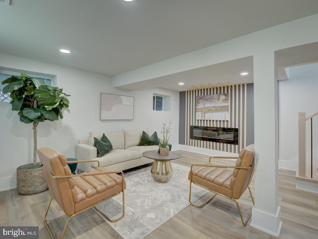 living room with a fireplace and light hardwood / wood-style flooring