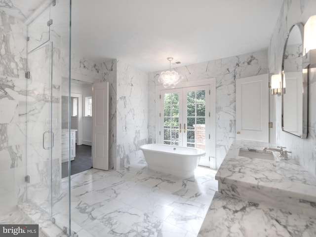 bathroom featuring vanity, french doors, plus walk in shower, and a chandelier