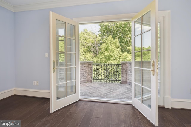 doorway featuring crown molding, dark wood-type flooring, and french doors