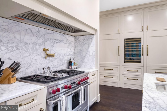 4825 Dexter Ter NW, Washington, DC 20007 - kitchen with range with two ovens, premium range hood, tasteful backsplash, dark wood finished floors, and light stone countertops