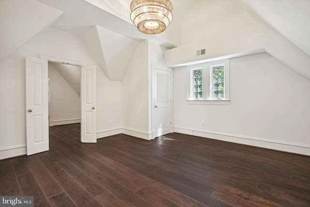 bonus room with dark hardwood / wood-style floors and lofted ceiling