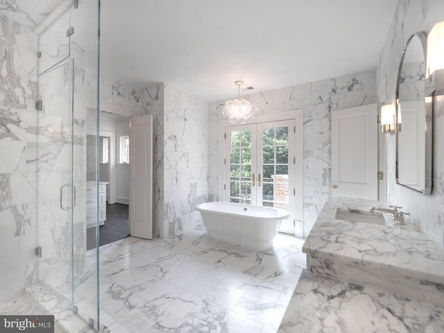 4825 Dexter Ter NW, Washington, DC 20007 - full bath featuring french doors, a chandelier, a marble finish shower, a freestanding bath, and healthy amount of natural light