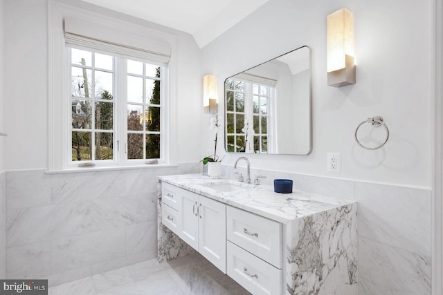 4825 Dexter Ter NW, Washington, DC 20007 - bathroom with vanity, tile walls, wainscoting, and marble finish flooring