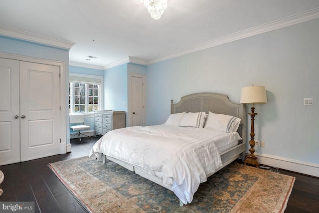 bedroom with dark hardwood / wood-style flooring, ornamental molding, and a closet