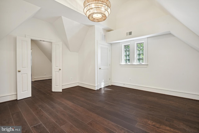 bonus room with dark hardwood / wood-style flooring and lofted ceiling