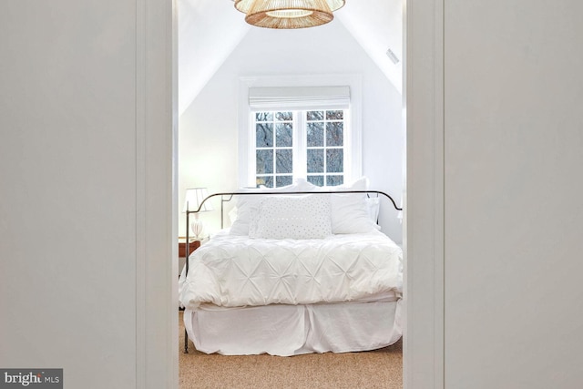 bedroom with carpet flooring and vaulted ceiling