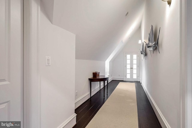 corridor featuring vaulted ceiling, french doors, and dark hardwood / wood-style floors